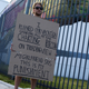 A man holds a placard outside the Mana Convention Center where the cryptocurrency conference Bitcoin 2021 Convention is held, in Miami, Florida, on June 4, 2021.